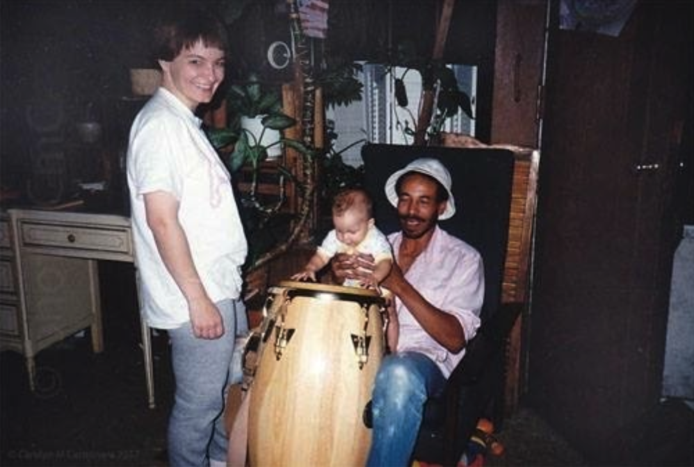 Nomi as a baby with parents